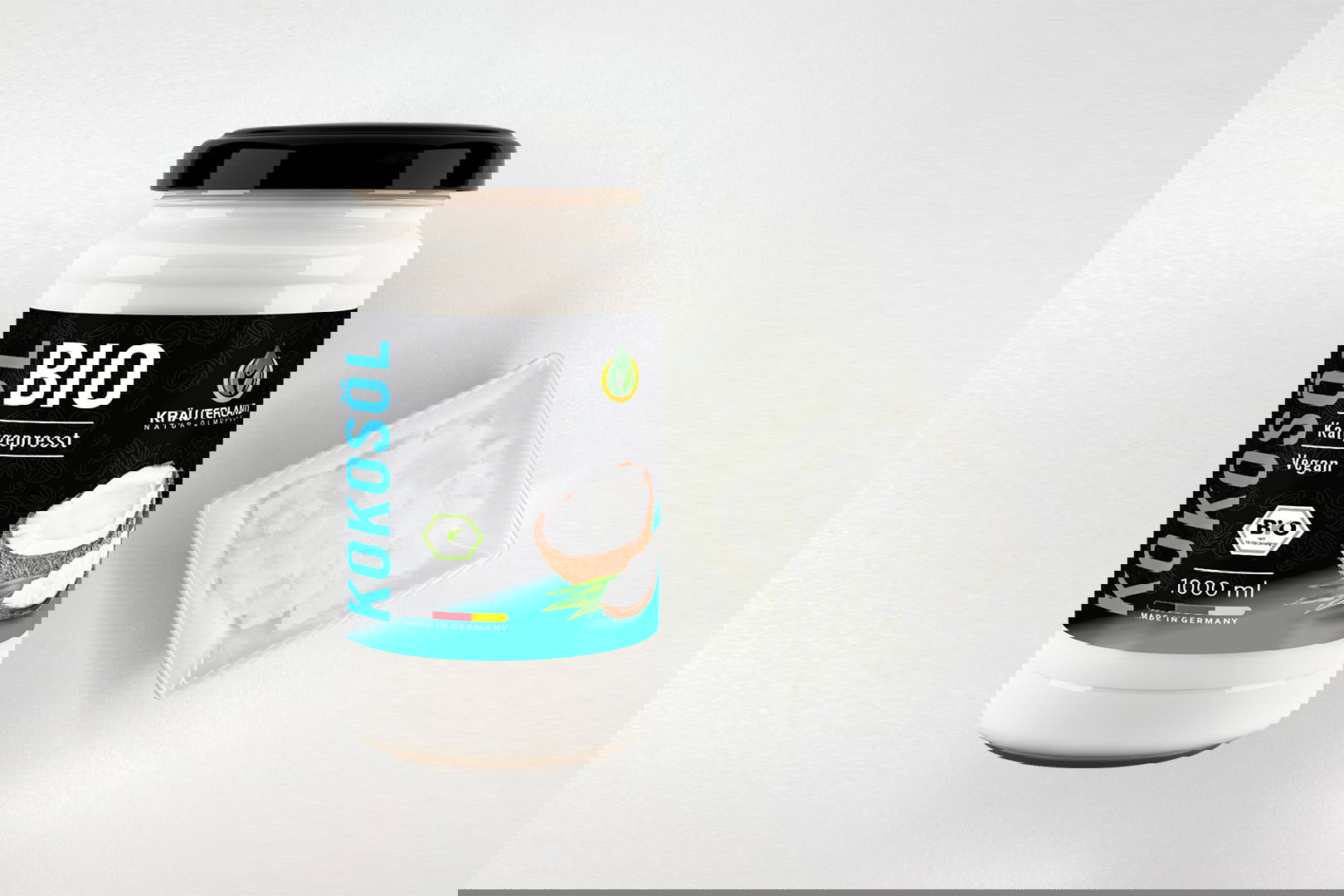 Kräuterland Bio Kokosöl 1000 ml kaltgepresst im Glas neben Schälchen mit festem Kokosöl bei Zimmertemperatur