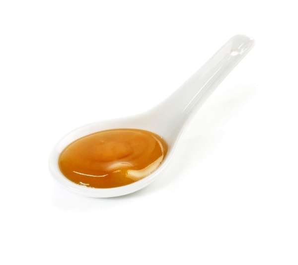 Manuka-Honig auf dem Löffel Manuka-Honig auf dem Löffel